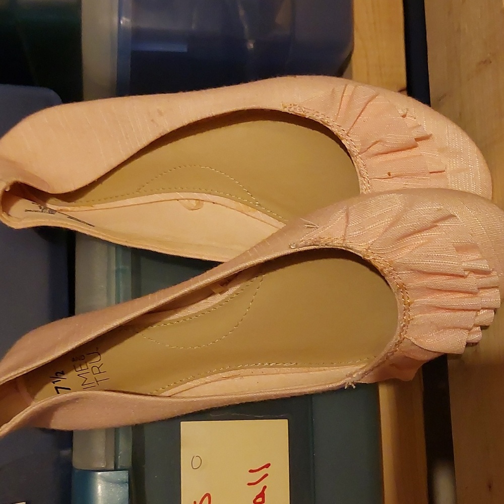 Pink flats with ruffle toe.
